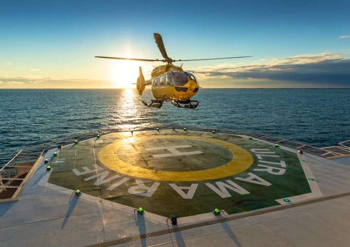 Helicopter landing on deck of Ultramarine Antarctic vessel in Antarctica