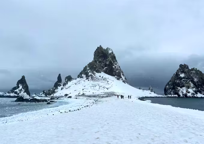 A rocky, snow-covered slither of scenery bisects a body of water