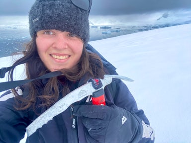 A woman takes a selfie while mountaineering in Antarctica
