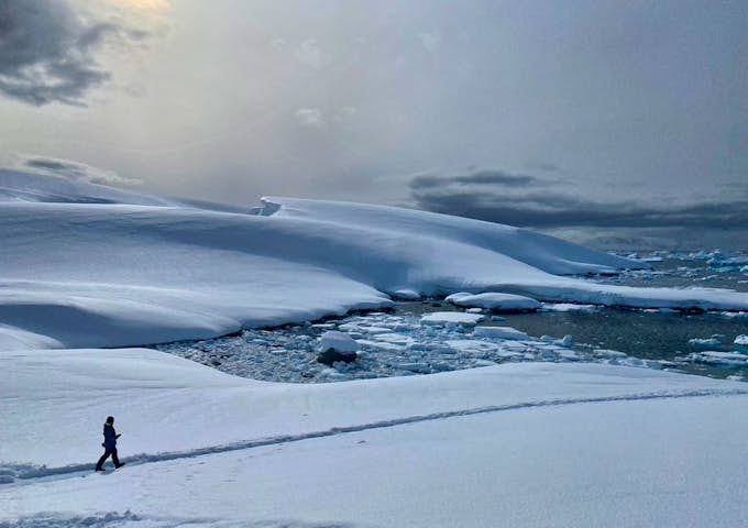 A woman walks through the snow in Antarctica 
