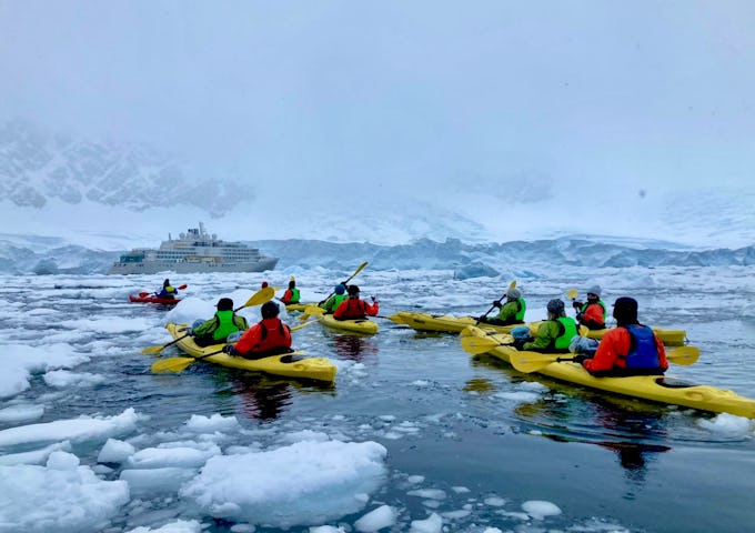 Group of kayakers in Antarctic waters
