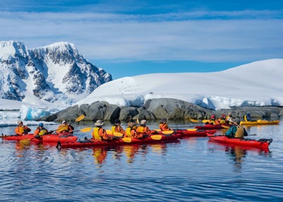 A groups of kayakers on the Antarctic Peninsula