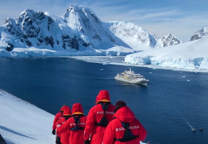 Walking to a viewpoint on the Antarctic Peninsula above Silver Endeavour luxury cruise ship