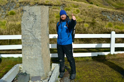 Tourist at Shackleton's grave in Grytviken