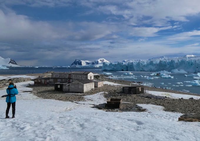 Tourists at the huts of Station E on Stonington Island in Antarctica