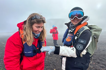 Tourist with Antarctic guide looking at krill