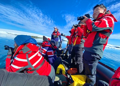 A zodiac full of photographers in the Antarctic peninsula