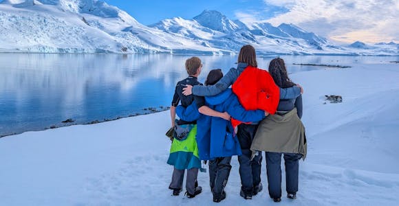 Group of tourists in the snow in Antarctica