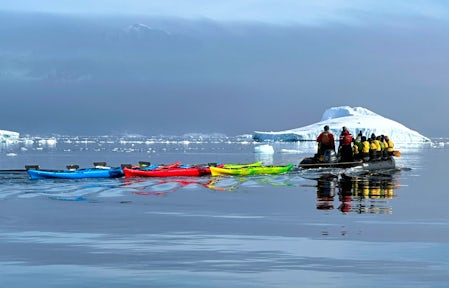Kayaks are towed at Cuverville Island, Antarctica, in December