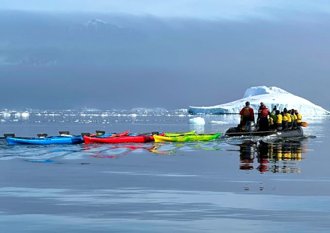 Kayaks are towed at Cuverville Island, Antarctica, in December