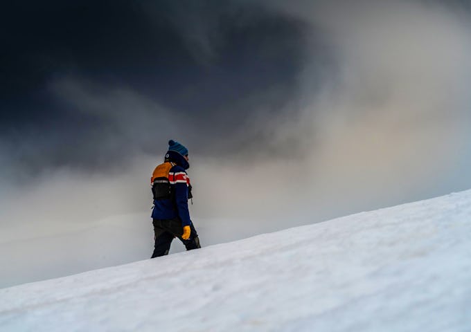 Expedition guide walking through snow in Antarctica in bad weather