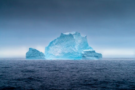 Iceberg in Antarctica with moody clouds