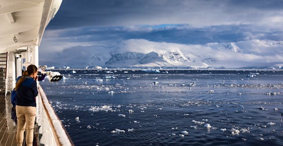 Looking out from a ship's deck across to the snowy landscape of the South Shetlands, Antarctica