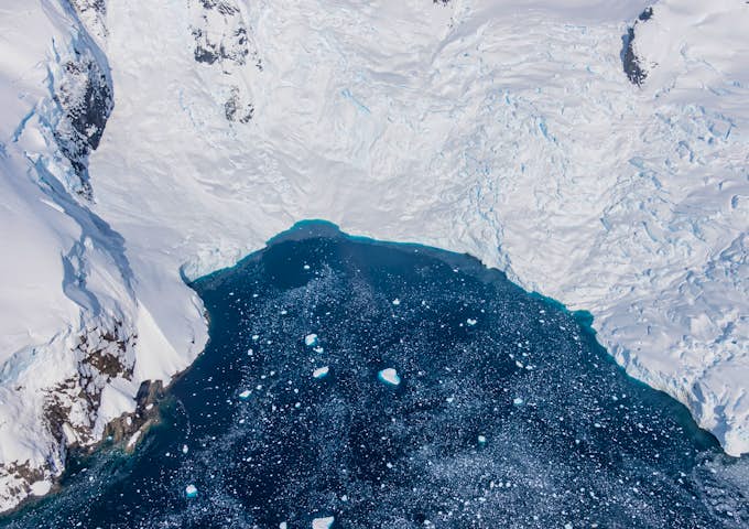A bird's eye view of an icy bay taken from a helicopter while flightseeing in Antarctica